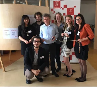 Photograph of the studio team standing together at a presentation event