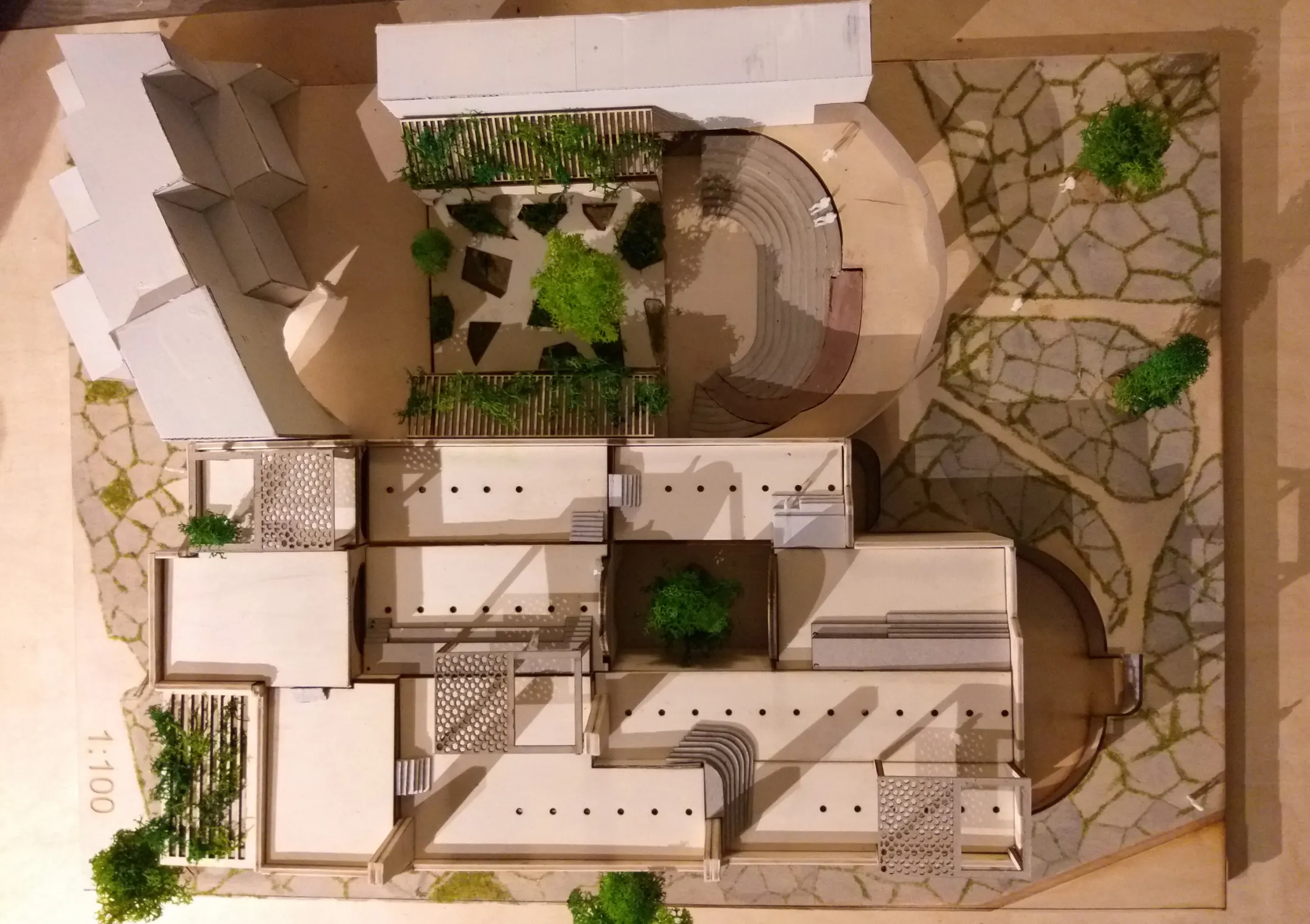Aerial photograph of the physical model showing courtyards, planting and stepped public spaces between vaulted buildings